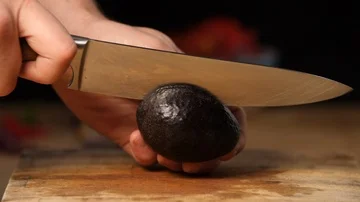 Avocado being prepared on chopping board by chef in slow motion  Stock Footage 85759933