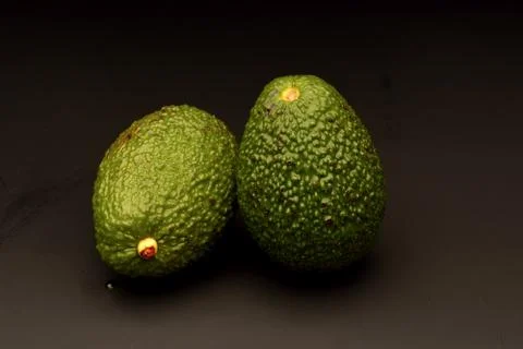 Avocado on black background Stock Photos