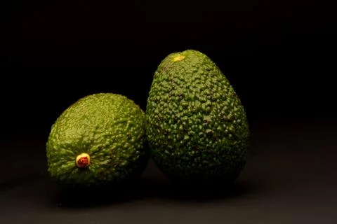 Avocado on black background Stock Photos