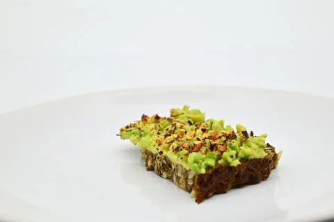 Avocado bread on a black rye bread Stock Photos