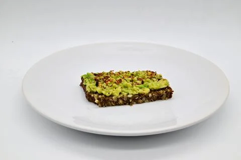 Avocado bread on a black rye bread Stock Photos