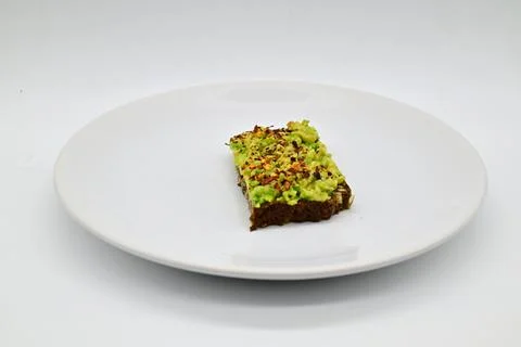 Avocado bread on a black rye bread Stock-Fotos