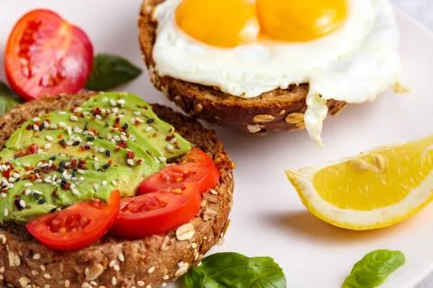 Avocado brunch. Egg toast on bread. Vegan Sandwich Stock Photos