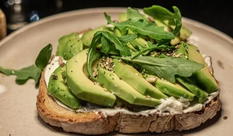 Avocado on cheese and bread Stock Photos