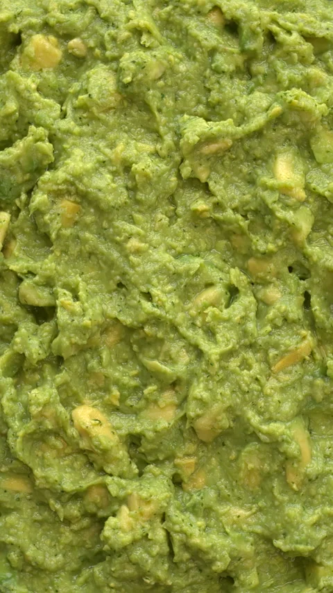 Avocado chunky guacamole background texture. Vertical video. Stock Footage 299929340