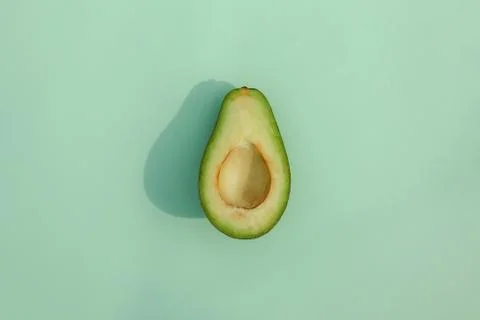 Avocado on a colored background food pattern Photos
