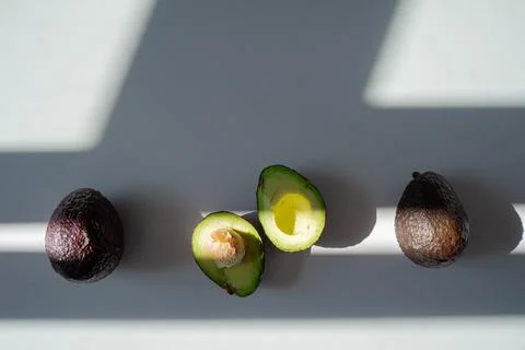 Avocado composition from above lies on the table Stock Photos