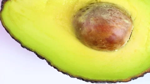 Avocado cut in half close up, rotating Stock Footage 318812097