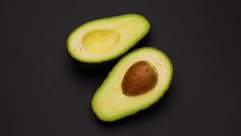 Avocado cut in half Video stock 299873517
