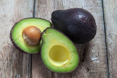 Avocado on a dark wood background Stock Photos