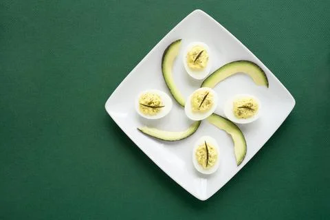 Avocado Deviled Eggs on Green Background Stock Photos