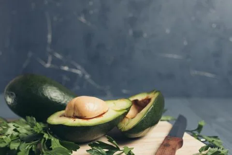Avocado on a grey background. Stock Photos