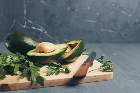 Avocado on a grey background. Stock Photos