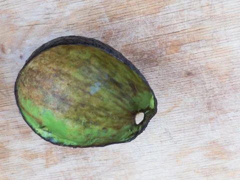 Avocado Hass  rind without pulp lying on a wooden surface Stock Photos