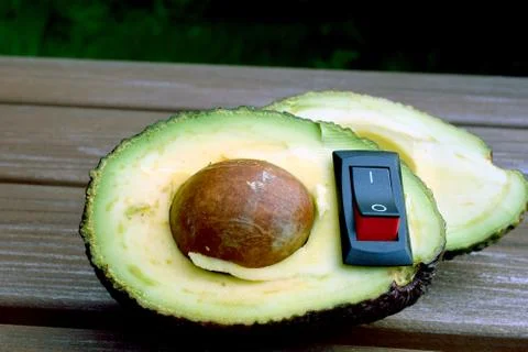 Avocado with inserted power switch Stock Photos
