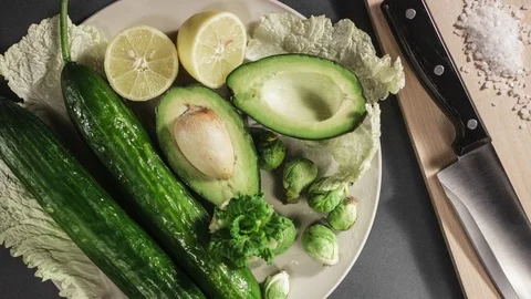 Avocado, Lemon, Cabbage, Cucumber And Other Vegetables Lying On Plate Stock Footage 83019604