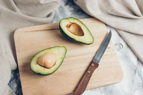 Avocado on a marble background. Stock Photos