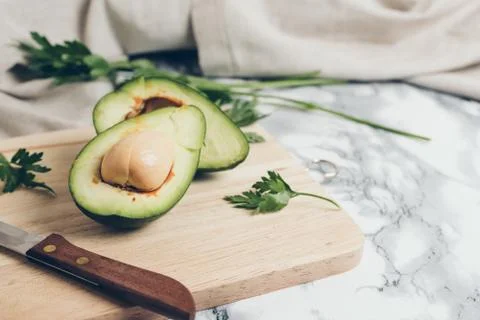 Avocado on a marble background. Stock Photos