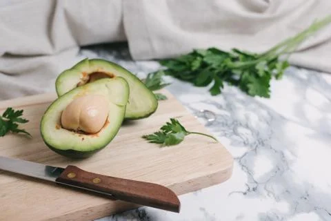 Avocado on a marble background. Stock Photos
