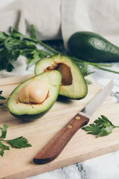 Avocado on a marble background. Stock Photos