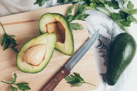 Avocado on a marble background. Stock Photos
