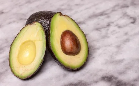 Avocado on marble surface Stock Photos