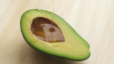 Avocado oil falling on top of the fruit slow motion slow motion of dripping 스톡 동영상 334641508