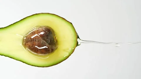 Avocado oil falling on top of the fruit slow motion slow motion of dripping 스톡 동영상 334641531