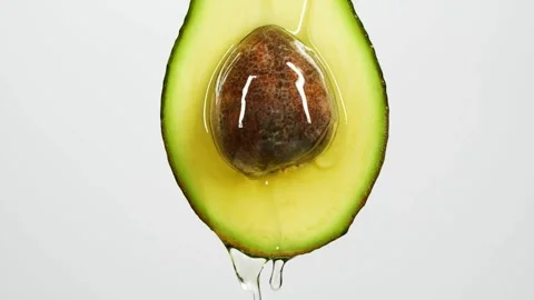 Avocado oil falling on top of the fruit slow motion slow motion of dripping 스톡 동영상 334641532