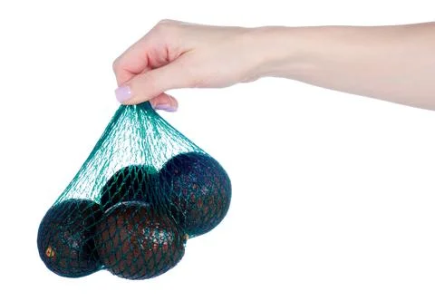 Avocado in package grin string bag in hand Stock Photos