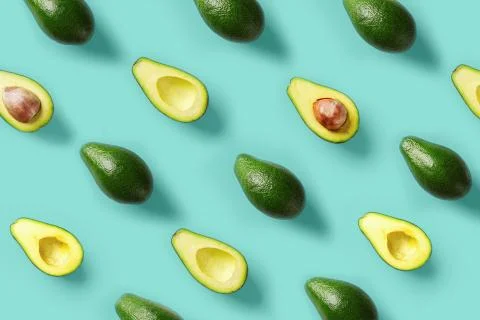 Avocado pattern on blue background. Pop art design, creative summer food concept Stock Photos