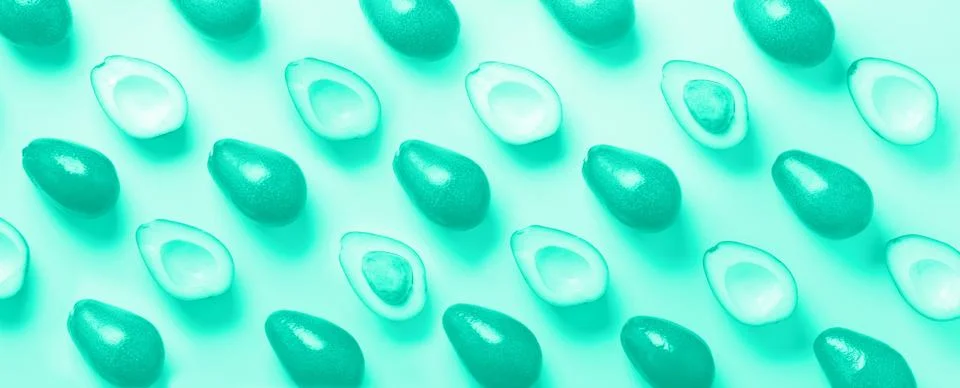 Avocado pattern on mint color background. Top view. Trendy green and turquoise Stock Photos