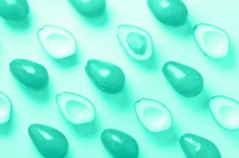 Avocado pattern on mint color background. Top view. Trendy green and turquoise Stock Photos