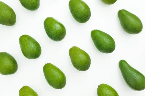 Avocado pattern on white background. Flat lay, top view. Food concept. Stock Photos
