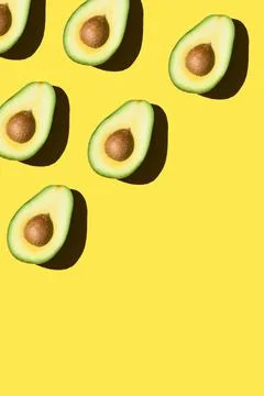 Avocado pattern on the yellow background Stock Photos