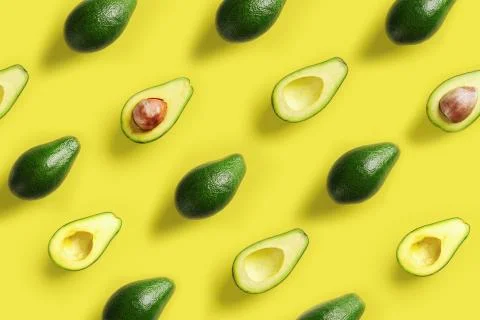 Avocado pattern on yellow background. Pop art design, creative summer food Stock Photos