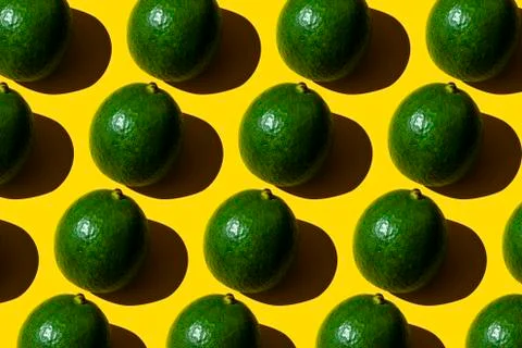Avocado pattern on yellow background. Top view. Stock Photos