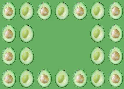 Avocado patterns with and without seed on green background with copy space Photos