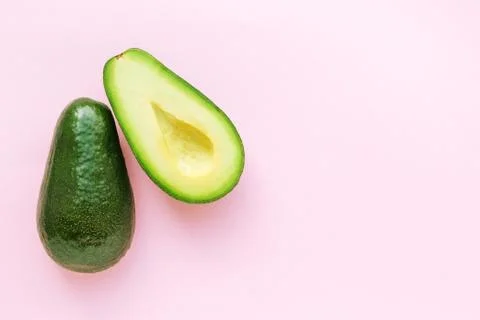 Avocado on pink background. Stock Photos