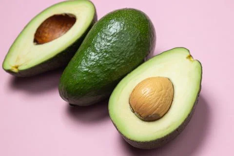Avocado on a pink background.  Stock Photos