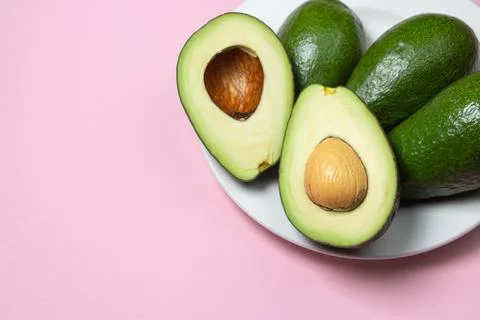 Avocado on a pink background.  Stock Photos