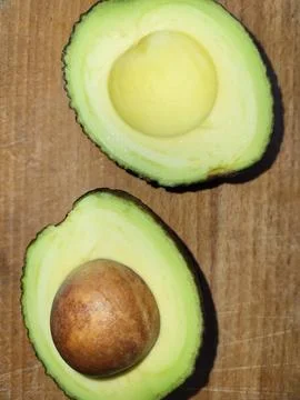 Avocado with pit on neutral background Stock Photos
