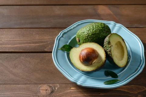 Avocado in plate on table Stock Photos