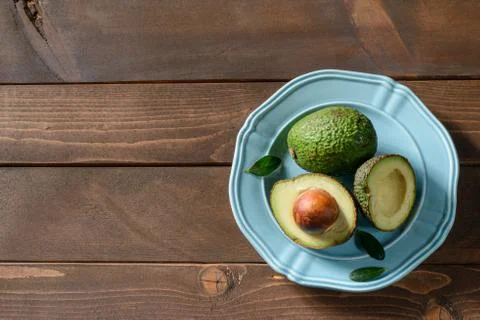 Avocado in plate on table Stock Photos