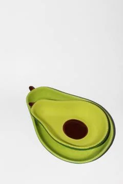 An Avocado Plate on white background, Green Plates. Stock Photos