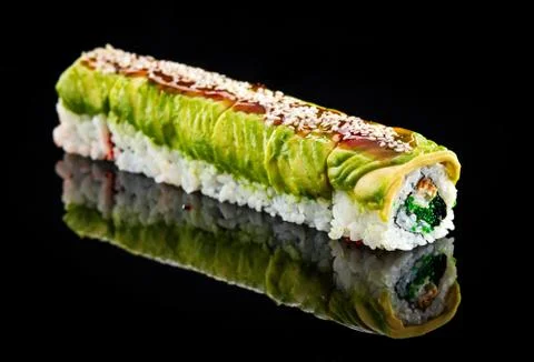 Avocado roll over black Stock Photos