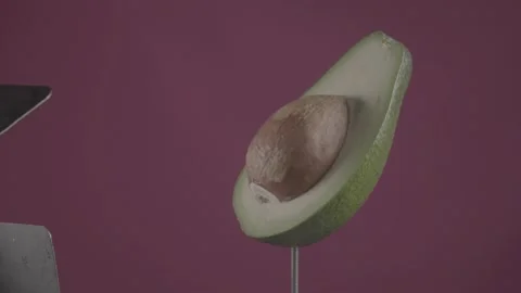 Avocado rotating with loop on fuchsia screen for chroma key Stock Footage 153969901