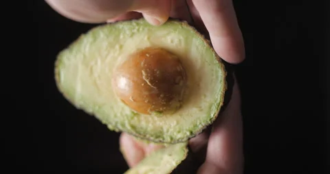 Avocado rotating opening close up vertical, studio close up Stock Footage 254134248