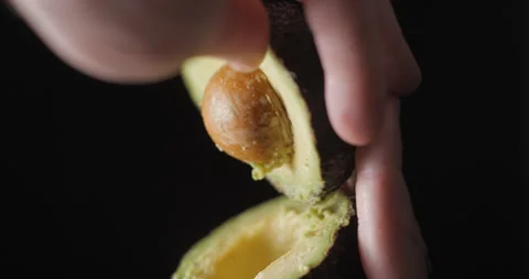 Avocado rotating opening close up vertical, studio close up Stock Footage 254134249