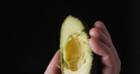 Avocado rotating opening close up vertical, studio close up Stock Footage 254134451